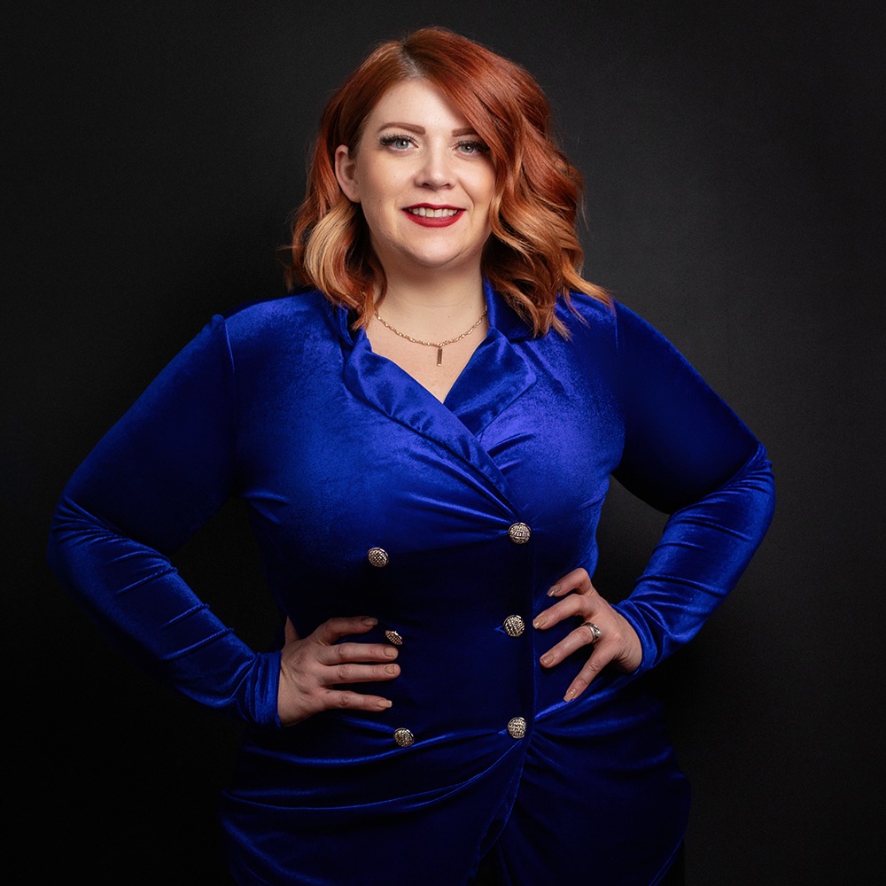 Redhead plus size woman posing for headshot photography in tapered blue blazer